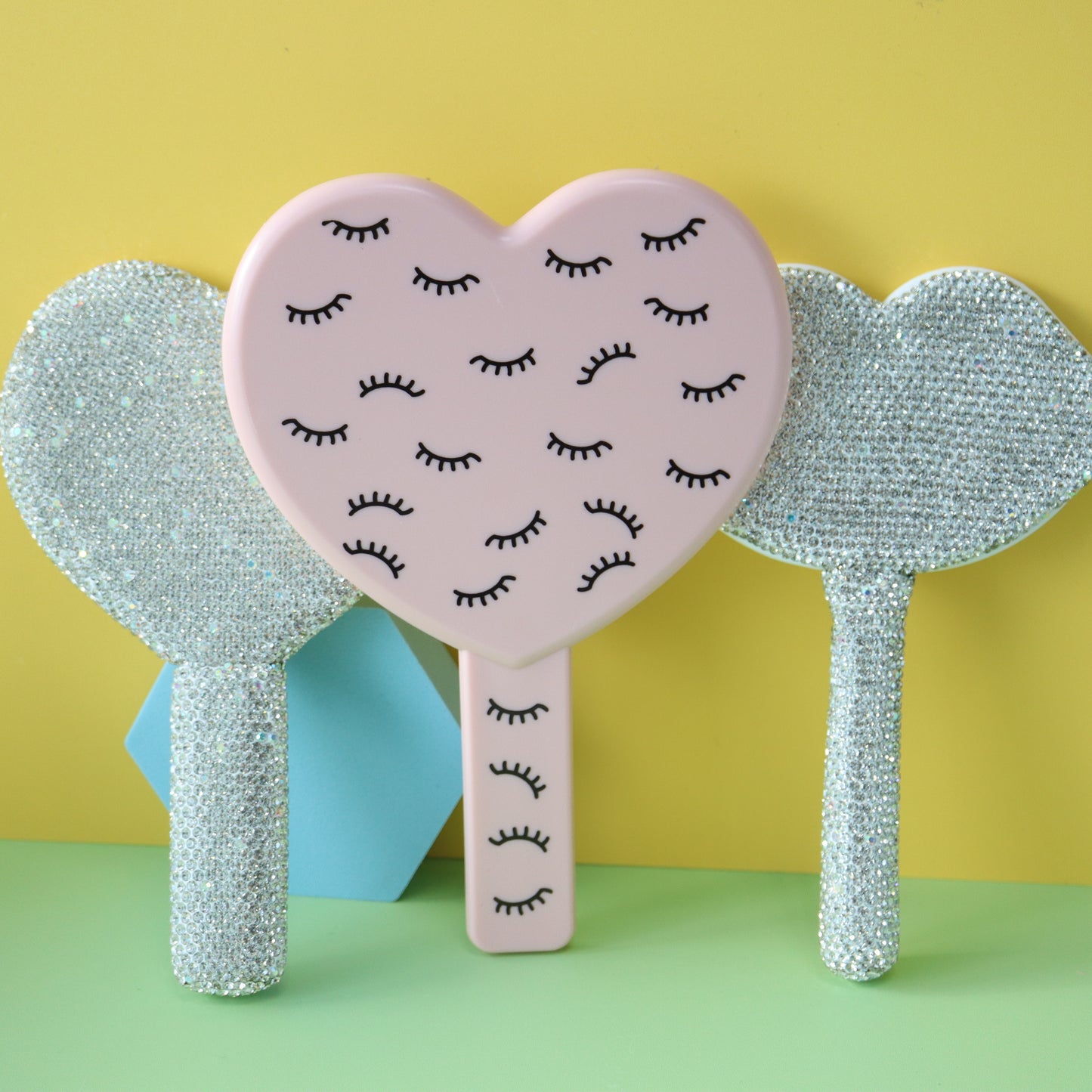 Handheld makeup mirror with diamond eyelash extension