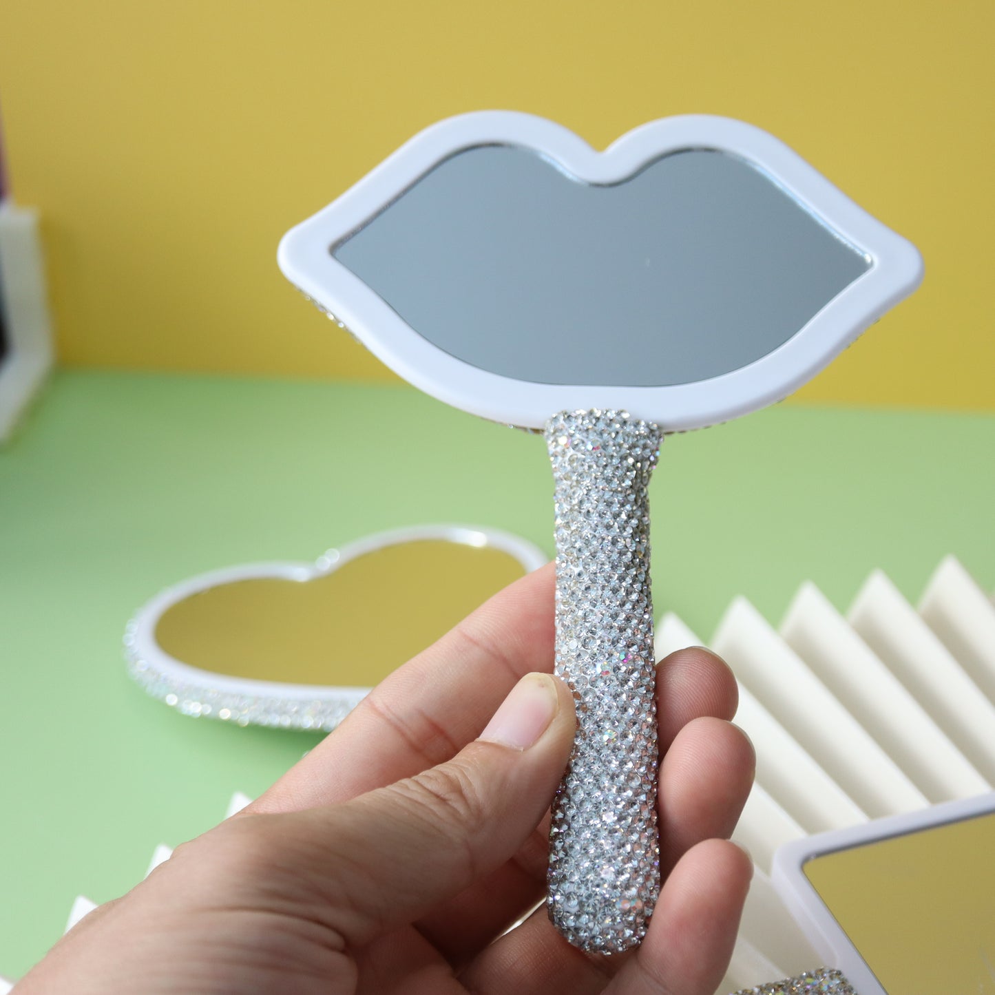 Handheld makeup mirror with diamond eyelash extension